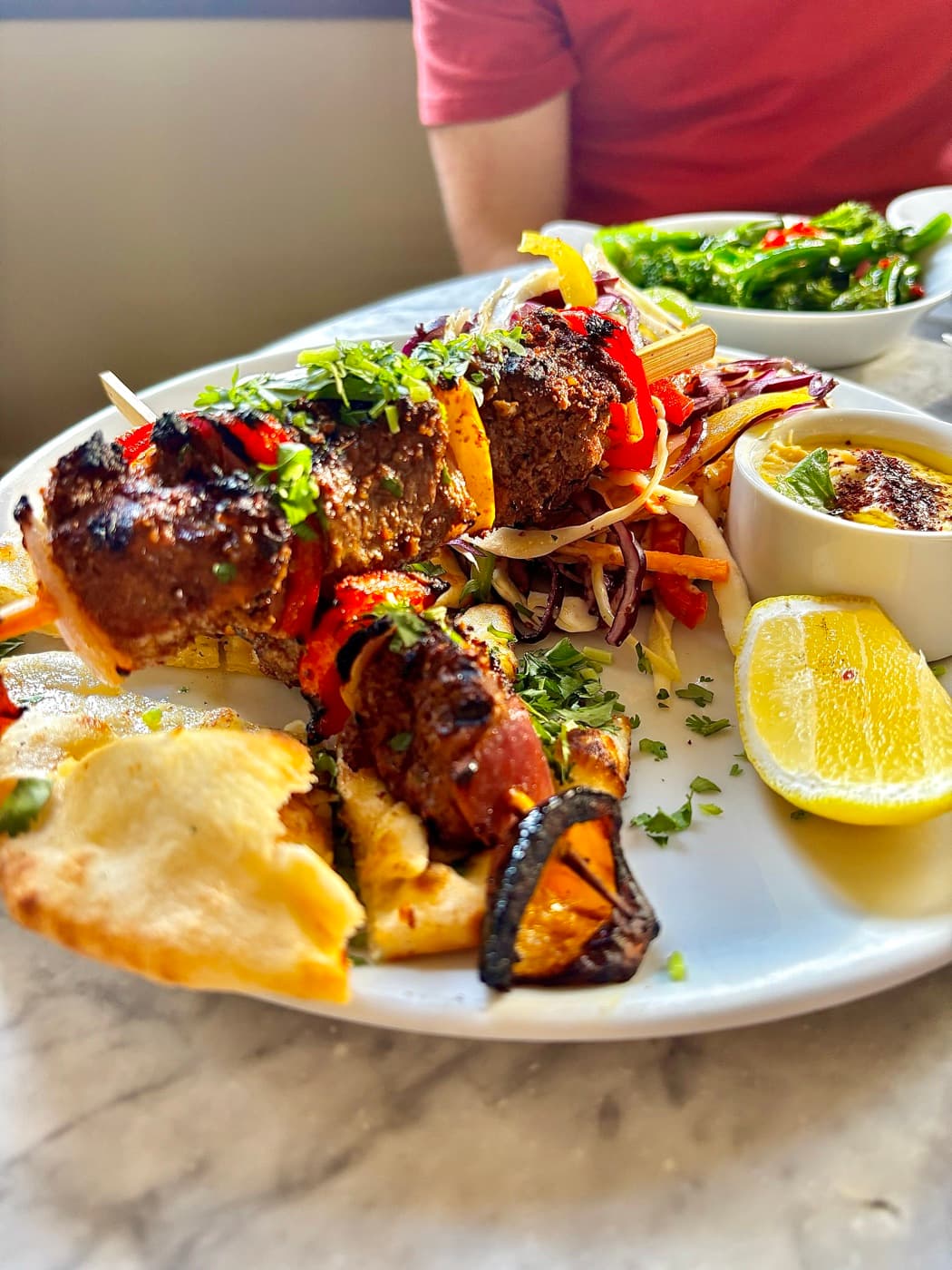 Moroccan lamb kebabs with summer slaw, hummus and garlic flatbread at Branca