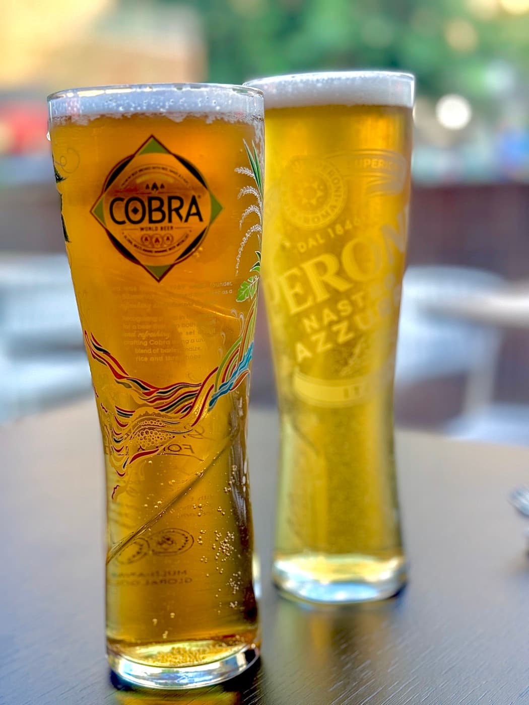 Two beers at Tempering — a Cobra and a Peroni — poured tall on the outdoor tables