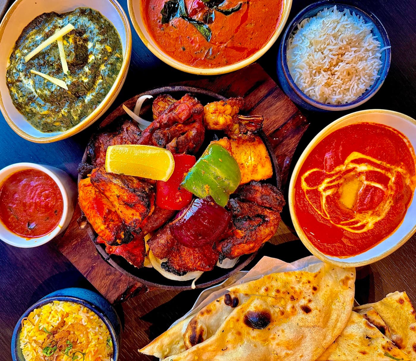 The full spread at Tempering: palak paneer, prawn gassi, butter chicken, a mixed grill sizzler, rice and naan